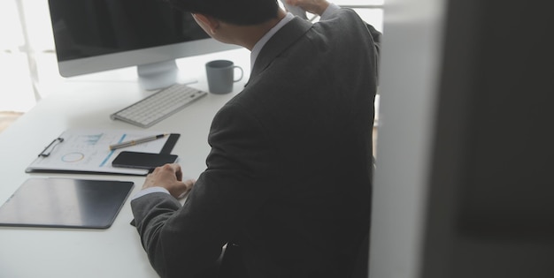 Asian Businesswoman Using laptop computer and working at office with calculator document on desk doing planning analyzing the financial report business plan investment finance analysis concept