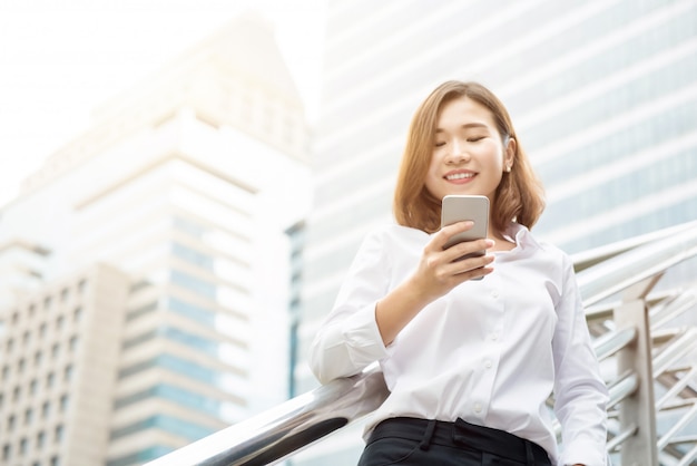 Asian businesswoman using smartphone in the city