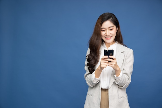 Asian businesswoman using smartphone on over white background