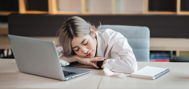 Asian businesswoman work and sitting nap Businesswoman after working job for a long time and sleepiness on table and tired overworkxA