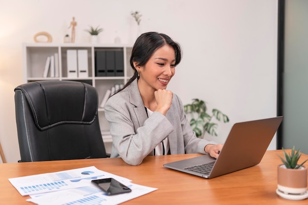 Asian businesswoman working on laptop in office Successful Asian business woman working on computer