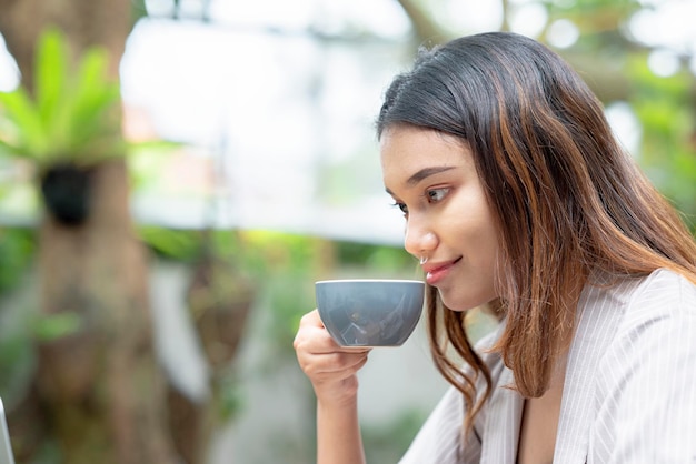 Asian businesswomen drink coffee while relaxing after work