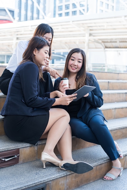 Asian businesswomen is working on laptop with colleague and teamwork. Teachnology and innovation for personal development on business successful.