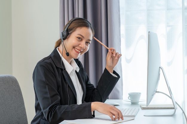 Asian businesswomen with headphone working on computer