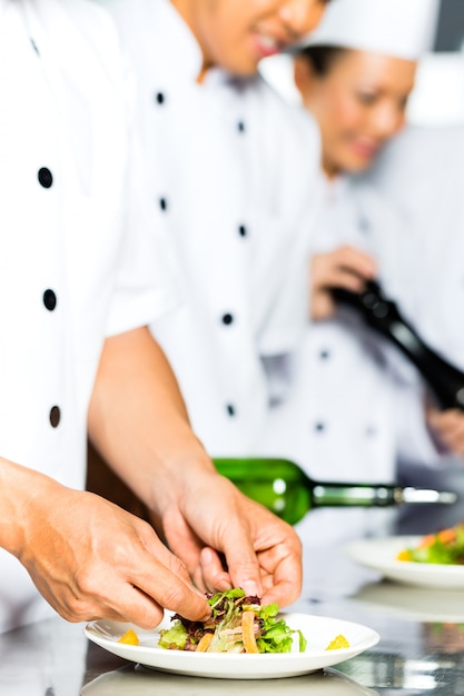 Asian Chef in restaurant kitchen cooking