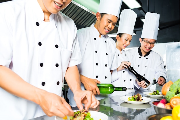 Asian Chef in restaurant kitchen cooking