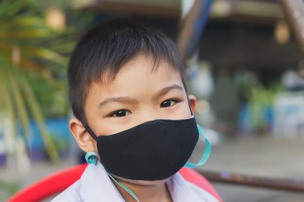 Asian child boy wearing fabric mask