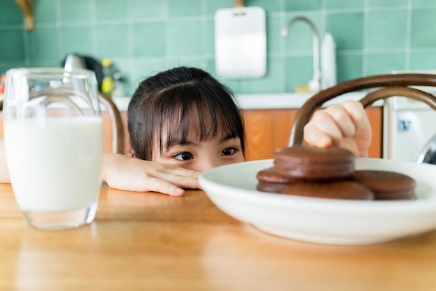 Asian child eating breakfast at home