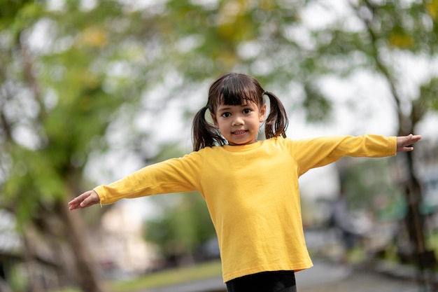 Asian child girl playing on the playground in the outdoor parkHappy moment and good emotion