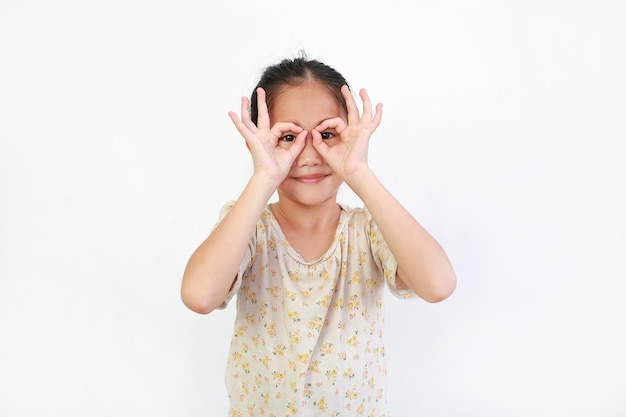 Asian child looking through imaginary binocular on white