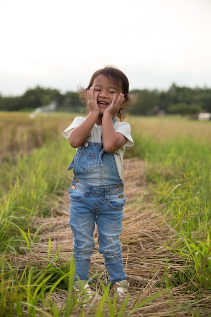 Asian child smiling to camera in paddy rice