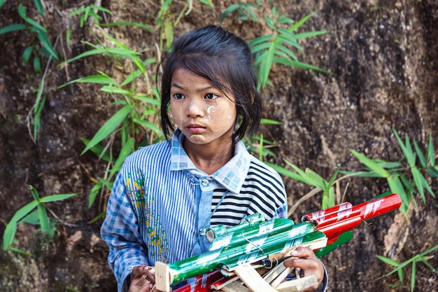 Asian children. Portrait of a cute pensive Asian girl from Myanmar. Burma