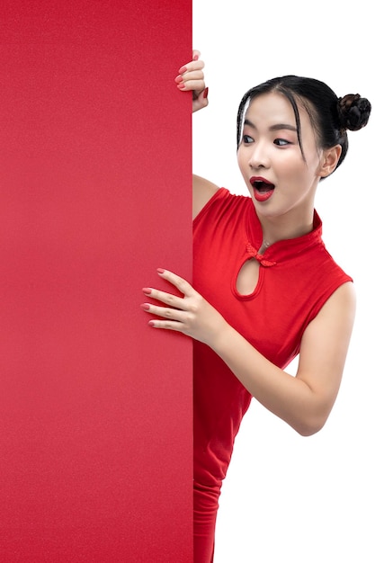 Asian Chinese woman in a cheongsam dress standing behind an empty wall