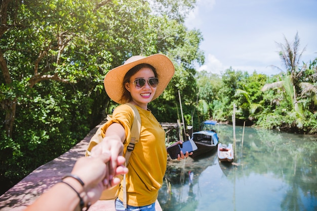 Asian couple holding hands, traveling nature. Travel relax. at tha pom-klong-song-nam. Krabi, in Thailand. Travel Thailand. Honeymoon, romantic.