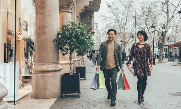 Asian couple shopping in barcelona