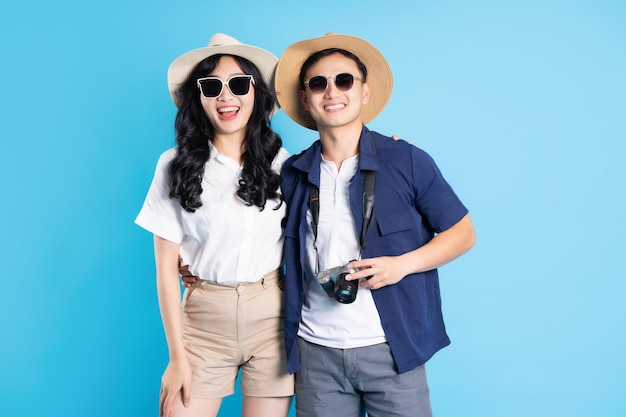 Asian couple traveling image isolated on blue background