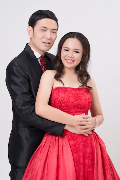 Asian couple wearing evening gown and dress