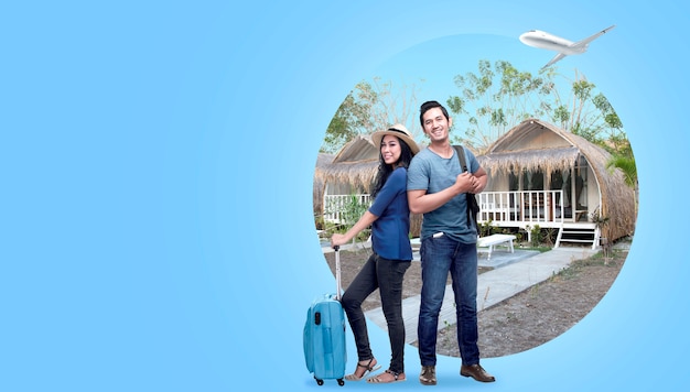 Asian couple with suitcase bag and backpack standing with cottage background