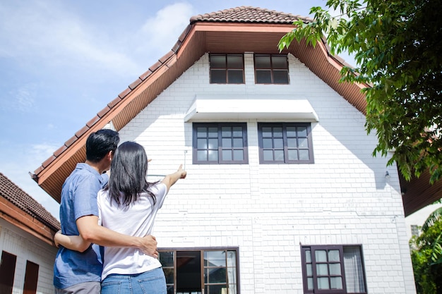 Asian couples are happy to have a new home Moving house Family concept real estate business copy space