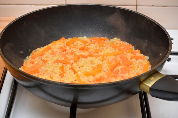 Asian cuisine rice with vegetables in a frying pan