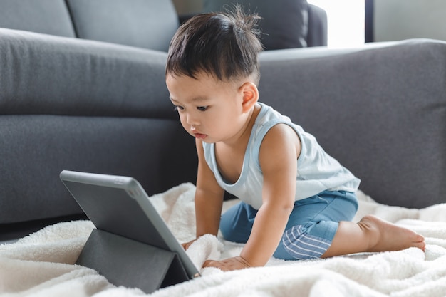 Asian cute baby boy watching digital tablet