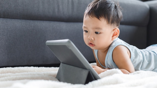 Asian cute baby boy watching digital tablet