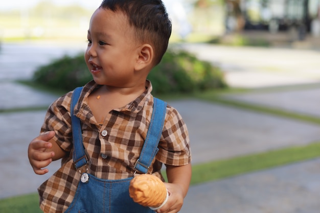 Asian cute toddler boy eating ice cream