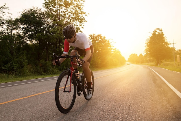 Asian cyclist drinking water after cyclisthealty and sport concept