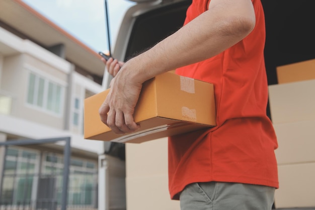 Asian delivery express courier young man use giving boxes to woman customer he wearing protective face mask at front home