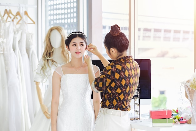 Asian designer working in wedding fashion store shop