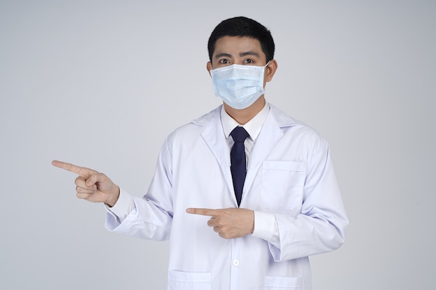 Asian doctor man wearing white coat and medical mask