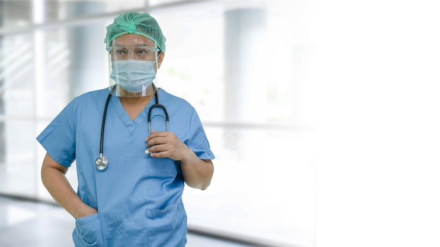 Asian doctor wearing face shield and PPE suit new normal to check patient protect safety infection Covid19 Coronavirus outbreak at quarantine nursing hospital ward