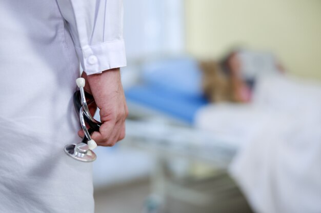 Asian doctor wearing uniform holding stethoscope