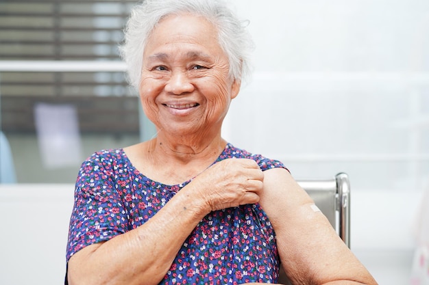 Asian elder senior woman getting vaccine for protect corona virus