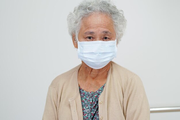 Asian elderly woman patient wearing a mask for protect Covid19 Coronavirus