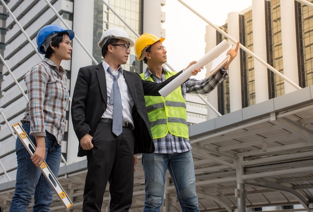 Asian Engineer and architect team checking construction at construction site