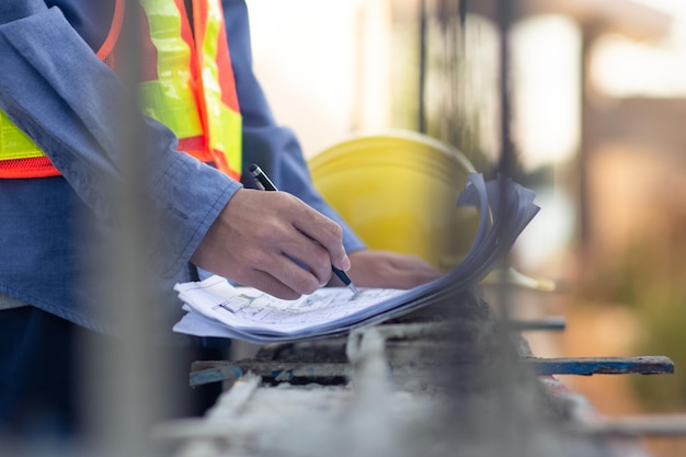 Asian Engineer construction are worker employee working by safety control helmet on site building