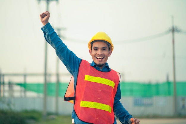 Asian Engineer standing outdoor on site construction posting confident Engineer construction happy job success with in target planning