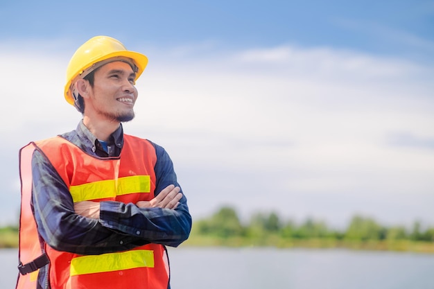 Asian Engineer standing outdoor on site construction posting confident Engineer construction happy job success with in target planning