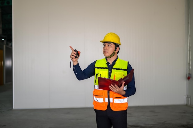 Asian Engineer worker Building sector and industrial workers concept Cheerful smiling asian construction manager inspector in helmet