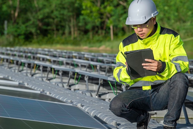 Asian engineer working at Floating solar power plantRenewable energyTechnician and investor solar panels checking the panels at solar energy installation