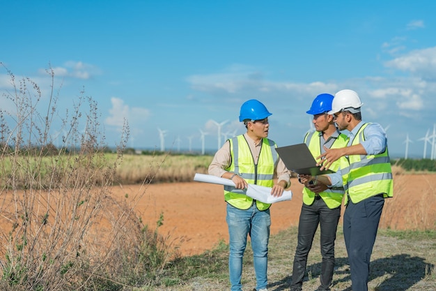 Asian engineers working in fieldwork outdoor. Workers walking and inspect construction and machine.