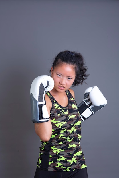 Asian ethnicity sportswoman with boxing gloves