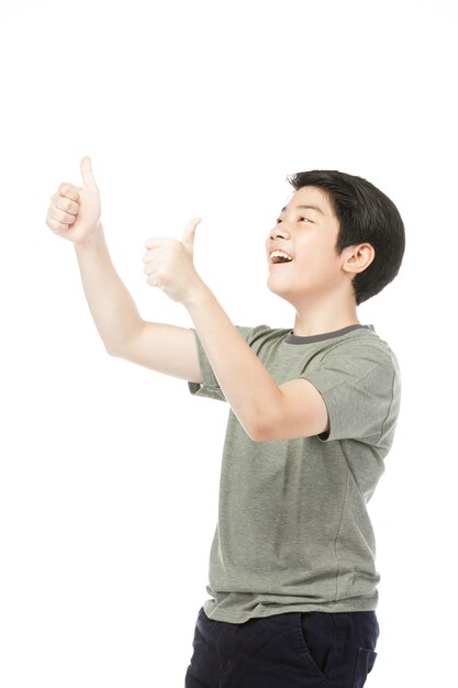 Asian excited boy in green-shirt giving thumbs-up.