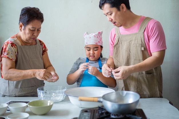 Asian families are helping each other in cooking