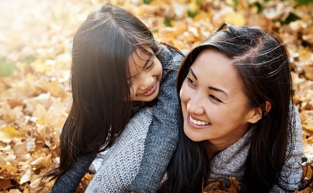 Photo asian family mom and daughter on floor in backyard for bonding support and love on child development parent kid and happy with hug to relax for childhood memories trust and care at home together