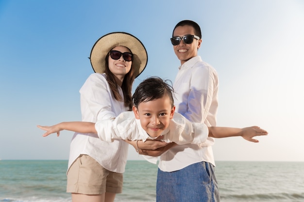 Asian family playing on the beach