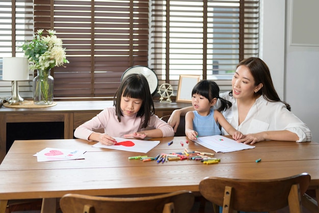 Asian family with children Drawing and painting on table in playing room at home Educational game