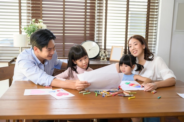 Asian family with children Drawing and painting on table in playing room at home Educational game