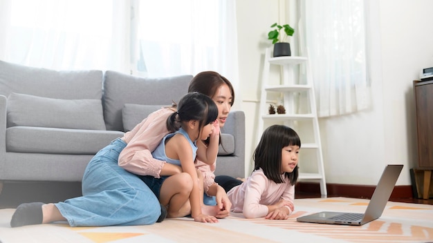 Asian family with children using laptop computer at home